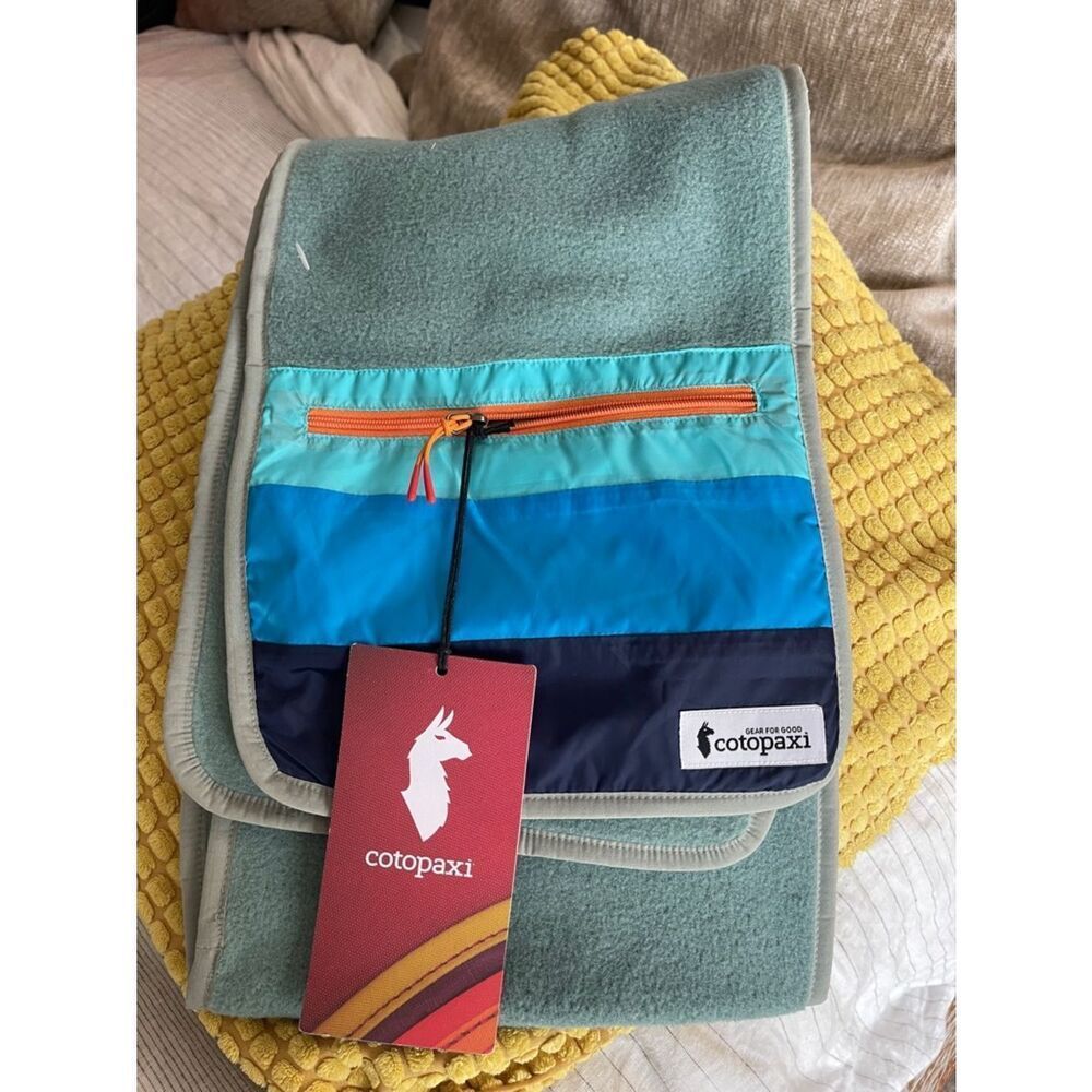 cotopaxi teal bag with blue and navy stripes and orange zipper